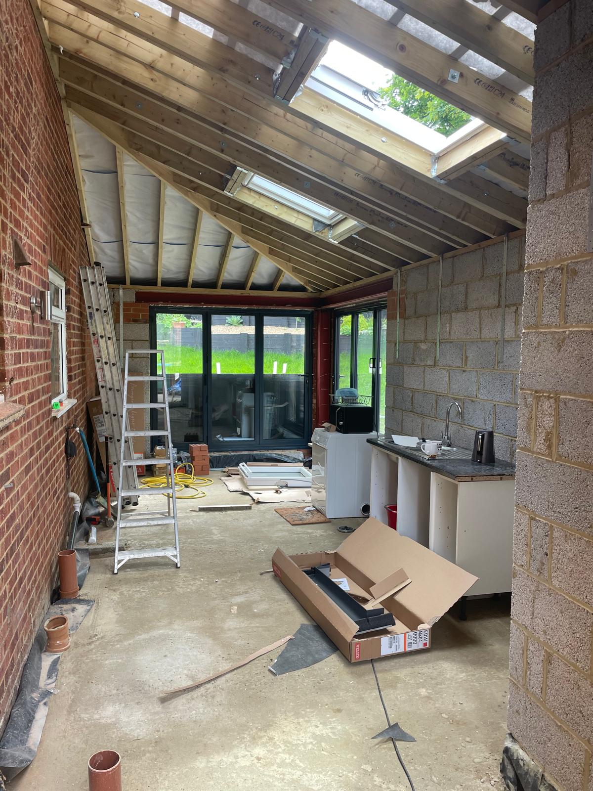 Vaulted rear extension with exposed rafters, rooflights and bi-fold doors under construction by DBD Builders Ltd