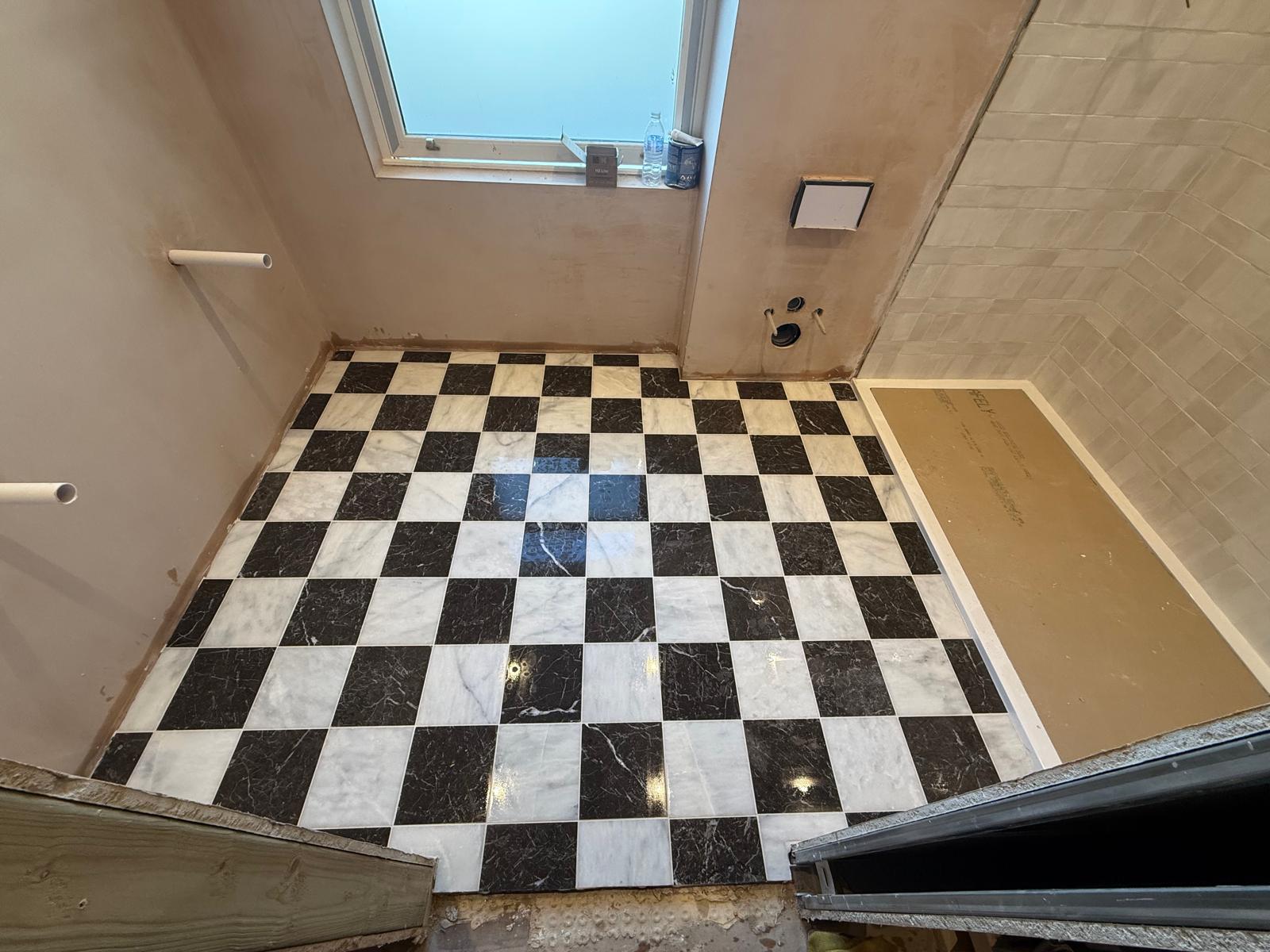 Marble chequerboard floor tiling laid in a bathroom by DBD Builders Ltd