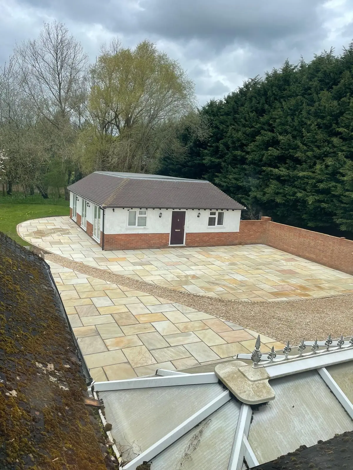 Renovated bungalow with new roof, rendered walls and full Indian sandstone patio by DBD Builders Ltd