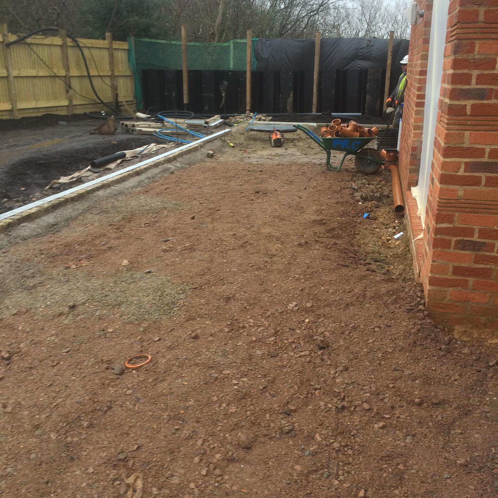 Drainage runs and hardcore prepared alongside a new build house by DBD Builders Ltd